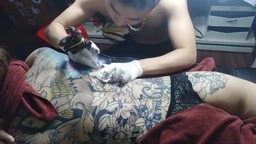 Sexy girl getting tattooed