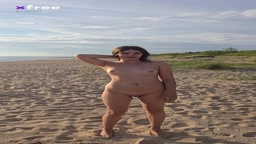 completely nude girl walks on the beach