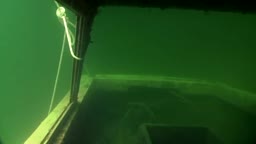 A girl explores the underwater world naked.