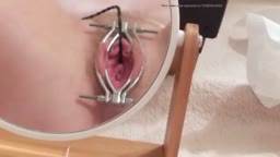 insert a toy into the urethra while looking in the mirr