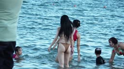 Filming bikini girls at the beach