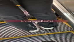 Big Piss on Asian Girl's Legs on Escalator