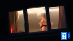 Voyeur watching neighbour at window.
