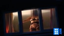 Voyeur watching neighbour at window.